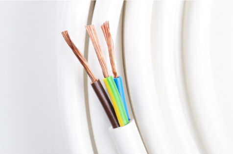 White electrical cable with exposed brown, blue, yellow-green, and black copper wires.