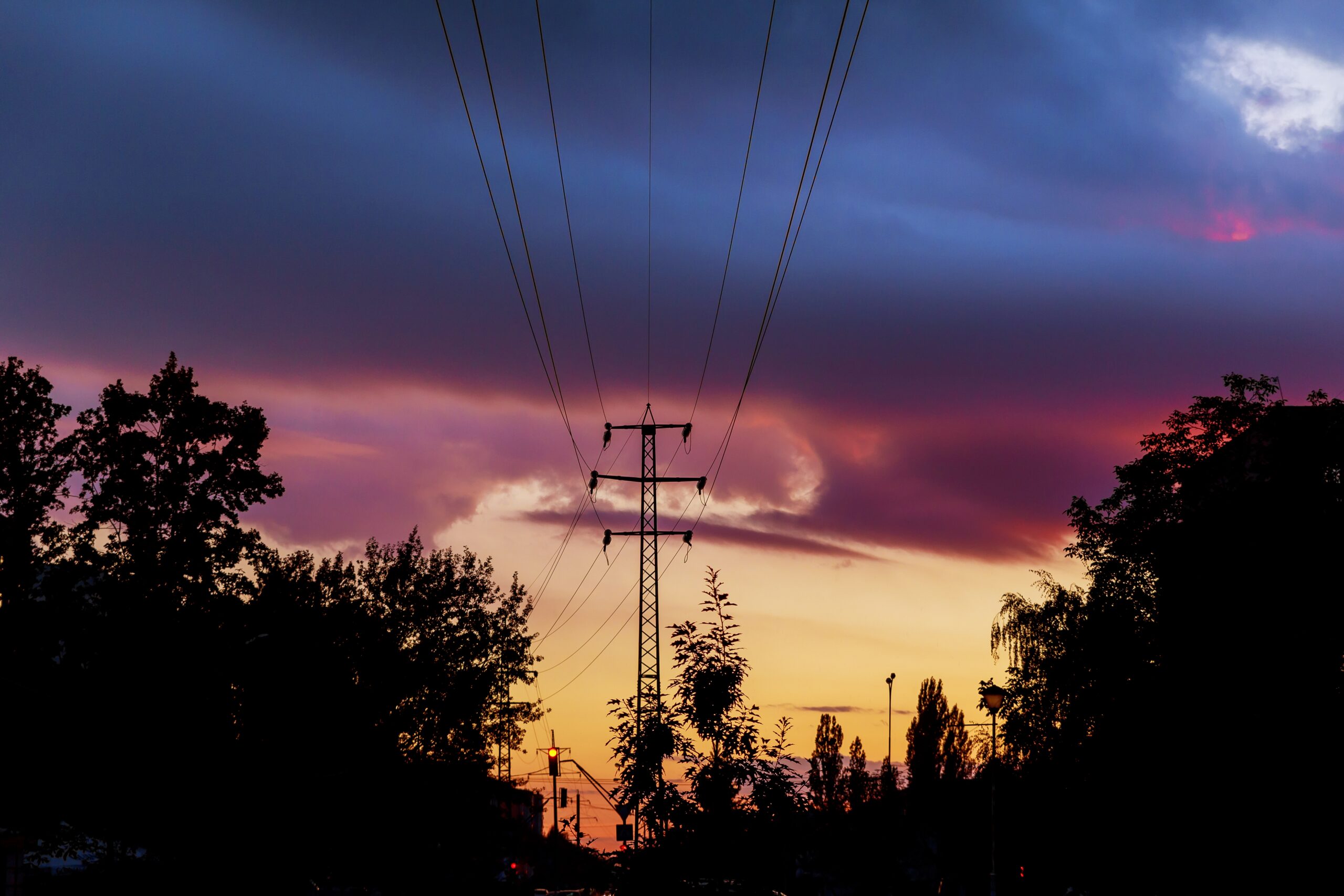 Power-lines silhouetted by sky at sunset The silhouette of the evening electricity transmission