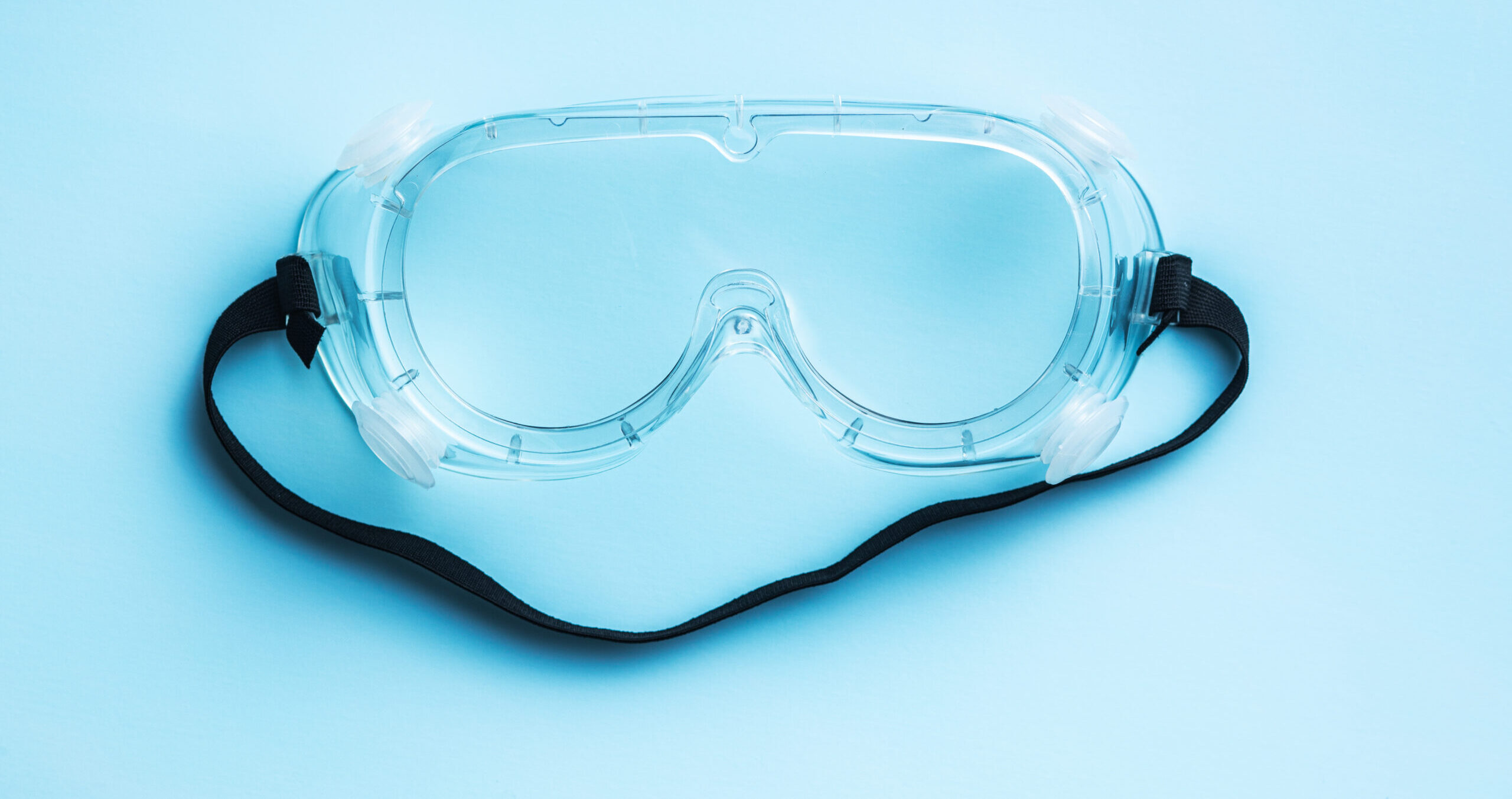 Protective goggles with a blue background.